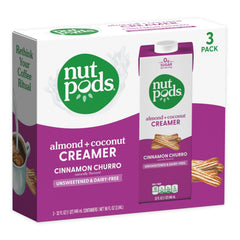 Creamy Nutpods Cinnamon Churro creamer in cup enhances dairy-free latte flavor.