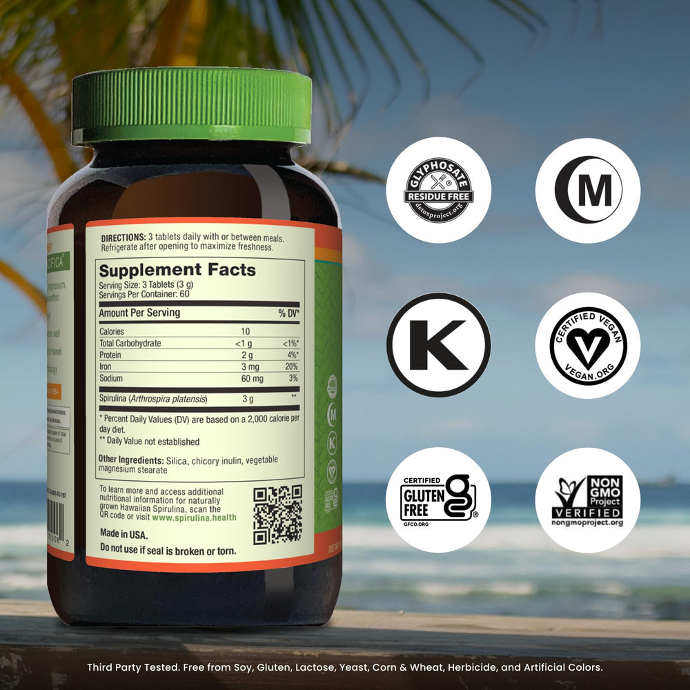 Nutrex Hawaii spirulina tablets close-up, convenient vegan supplement.