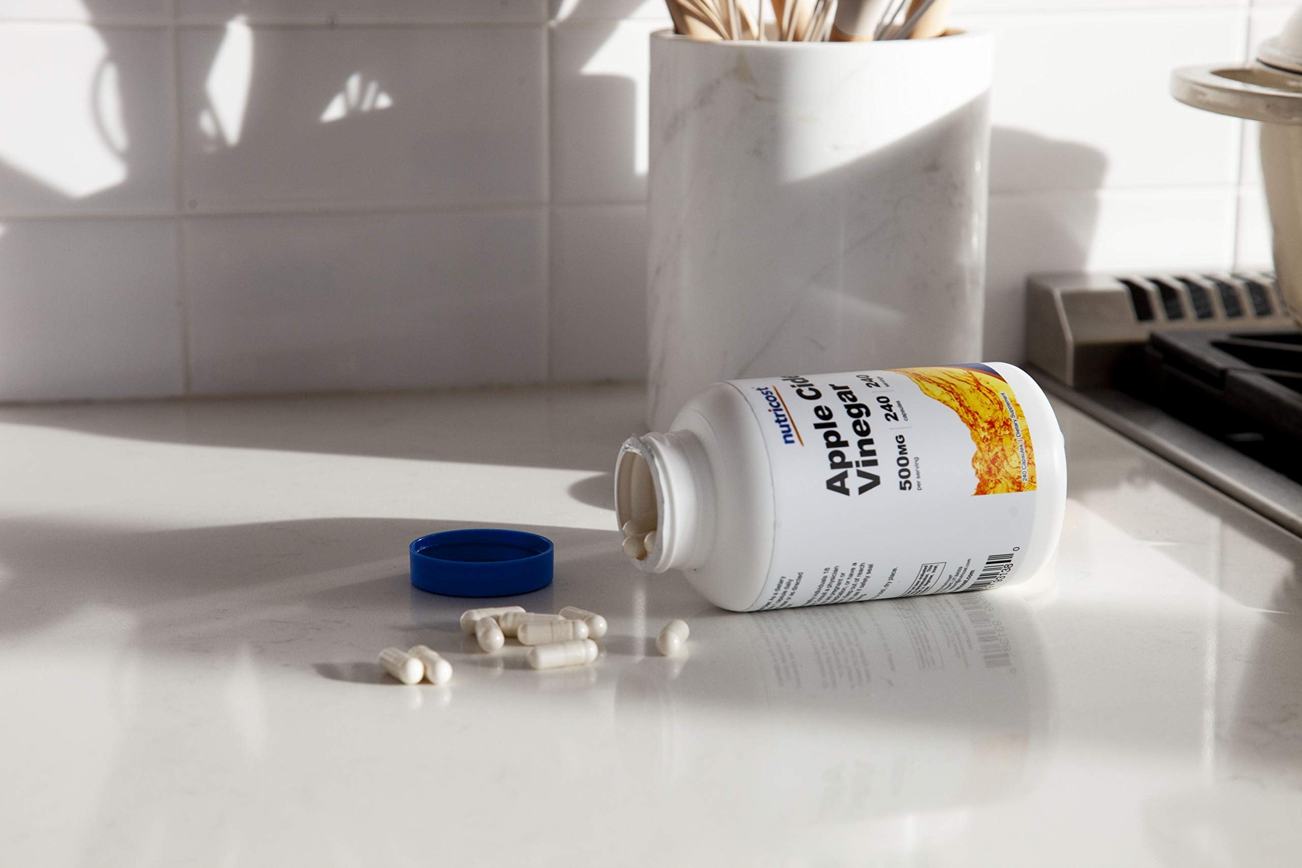 Nutricost capsule in hand showing travel-ready portability benefit