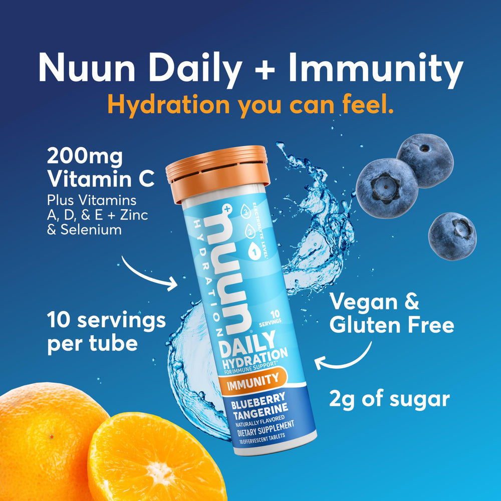 Nuun Immunity tablets dissolving in water for a fizzy blueberry-tangerine drink.