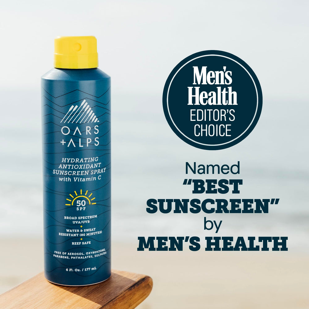 Applying Oars + Alps SPF 50 spray on skin for even protection.