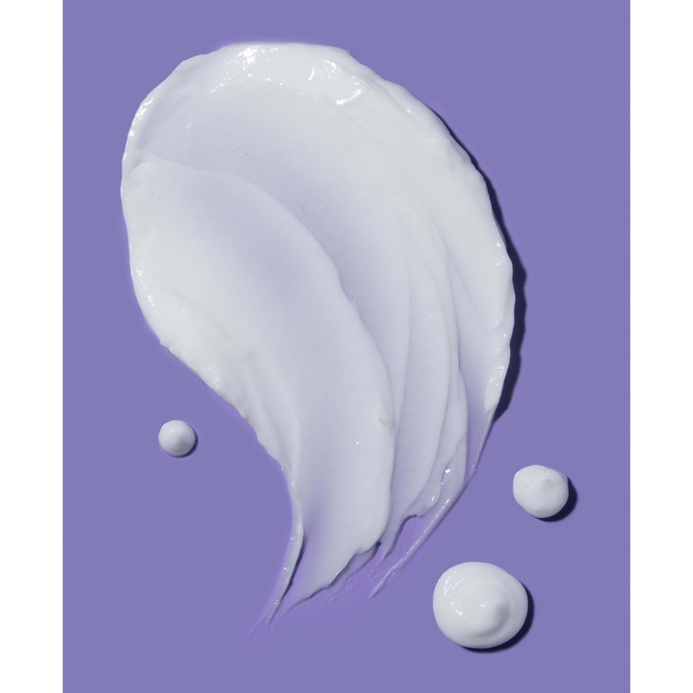 Frizz-control benefits evidenced by gloss and sleek strands with OGX coconut conditioner.