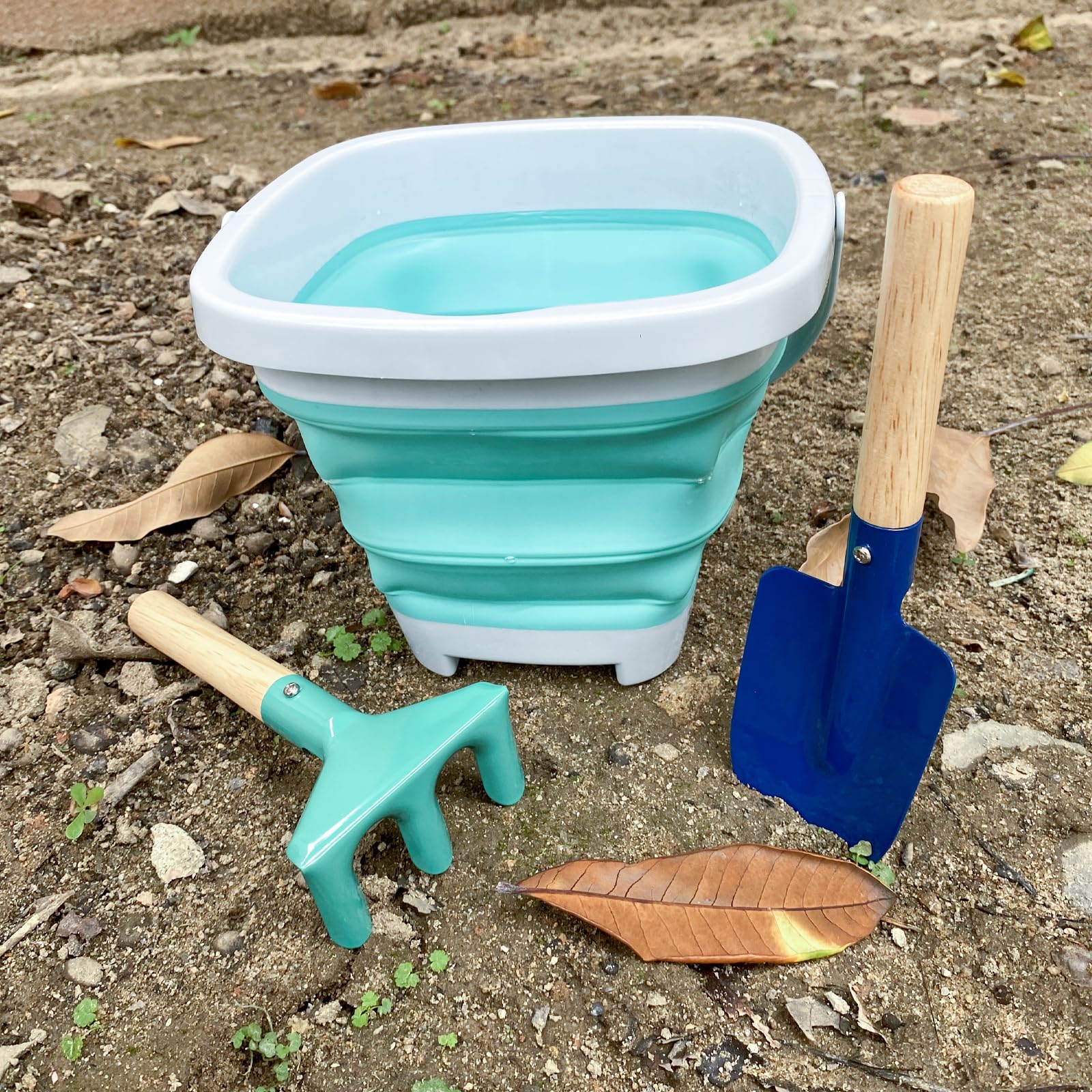 OKGD metal rake with wooden handle, smooth grip for soil loosening.