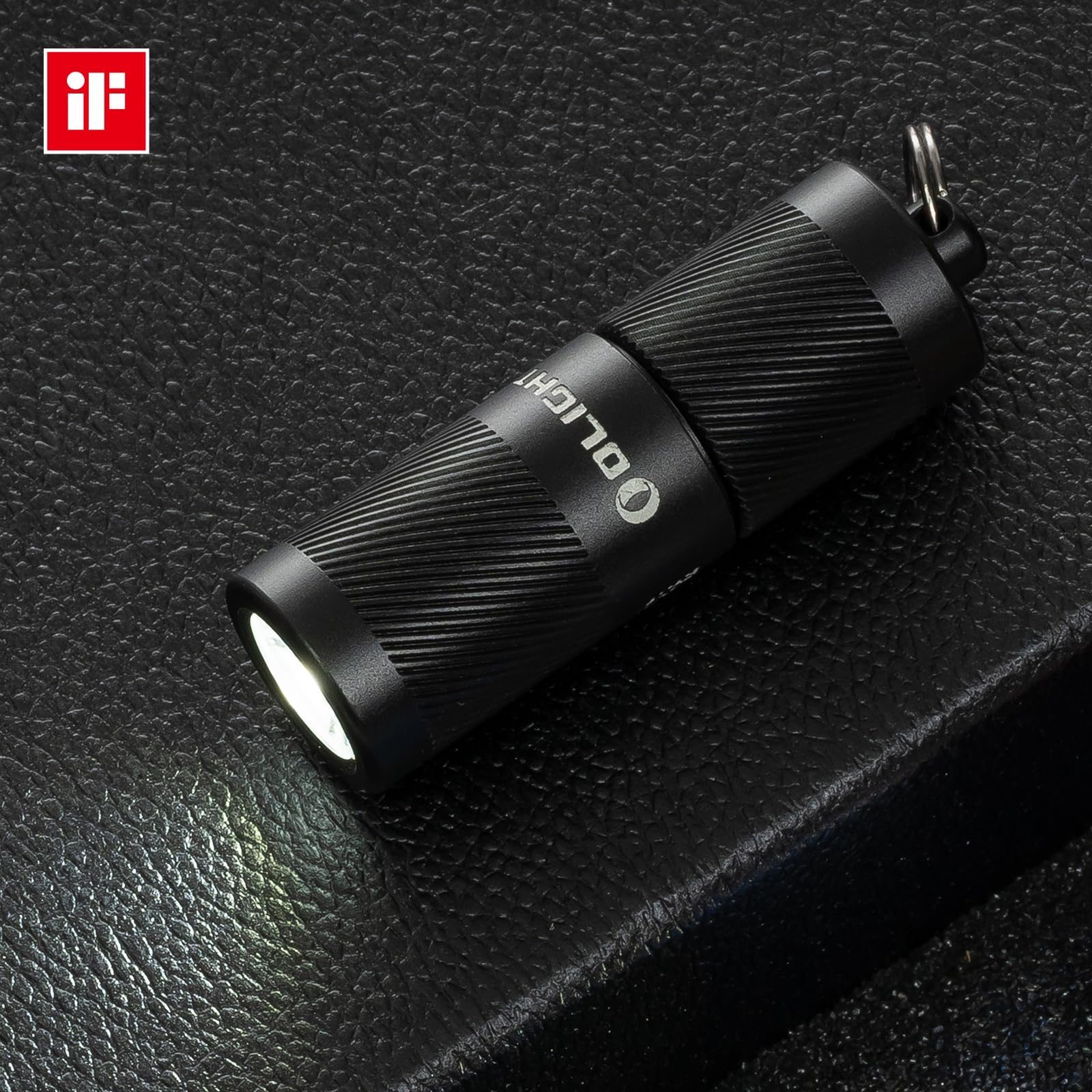 OLIGHT I1R 2 Pro EOS warm ambient beam on a nightstand.