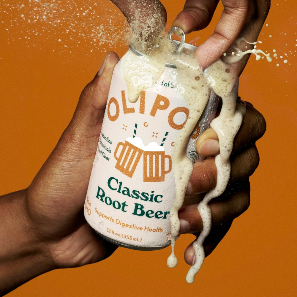 Close-up of OLIPOP brand logo on a root beer can highlighting clean ingredients.