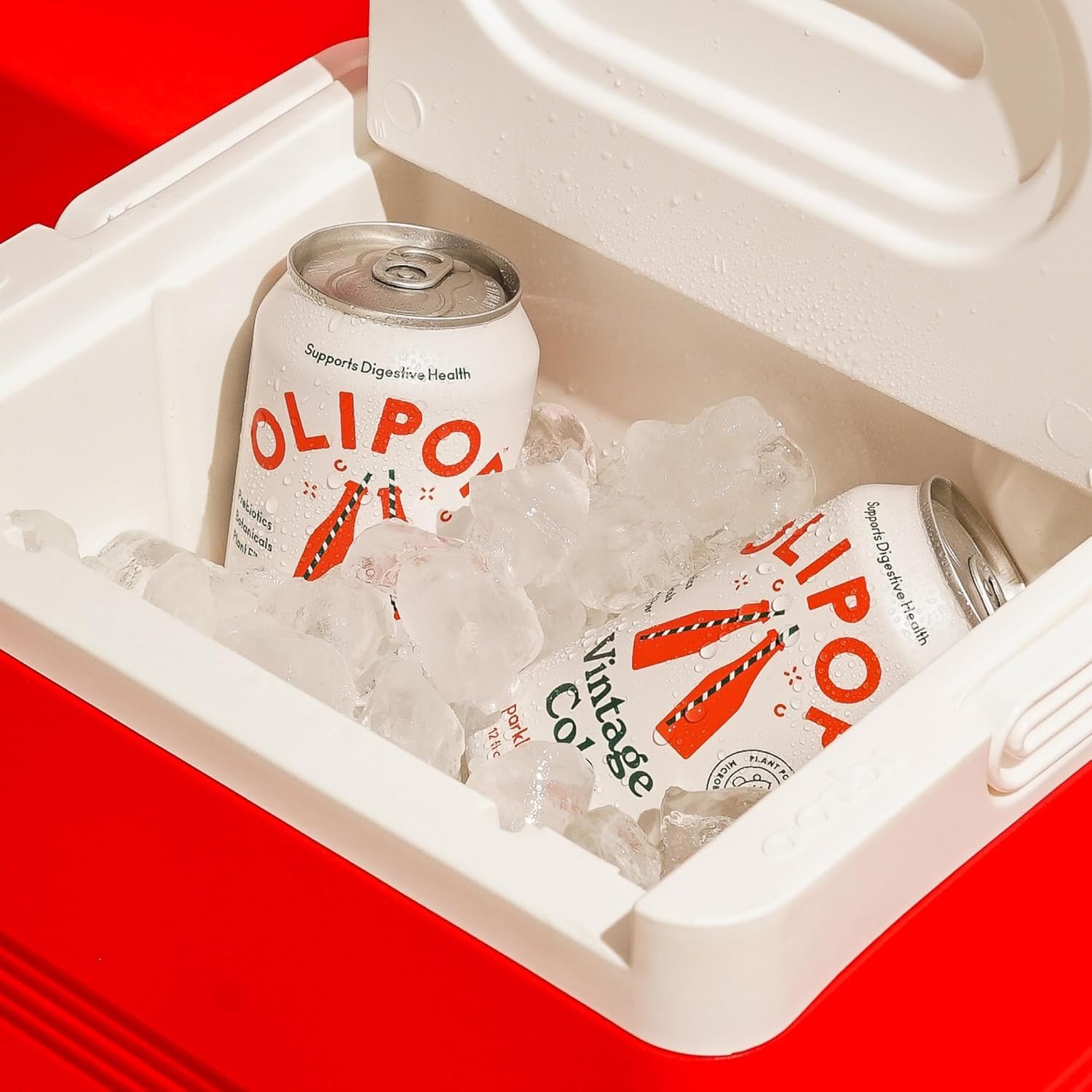 OLIPOP Vintage Cola being poured into a glass for a refreshing, prebiotic beverage.