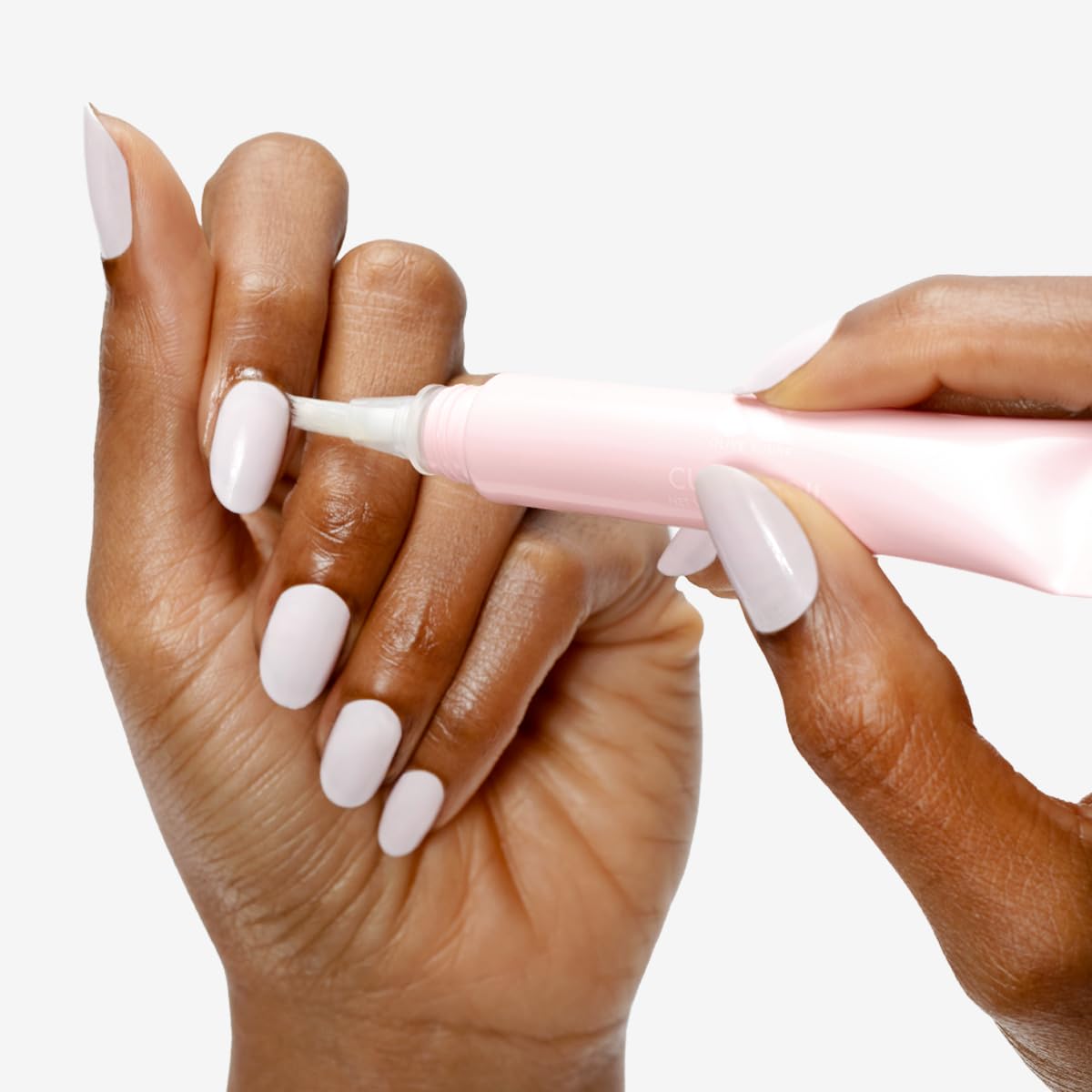 Close-up of Olive & June Cuticle Oil brush-tip applicator for targeted moisture