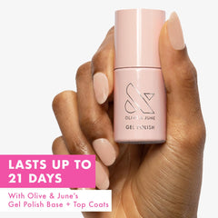 Olive & June gel base coat being applied on nails for durable coverage.