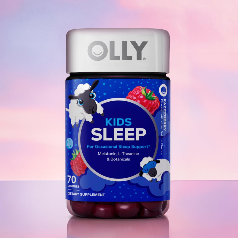OLLY Kids Sleep Gummies on a nightstand beside a cozy bedtime setup.