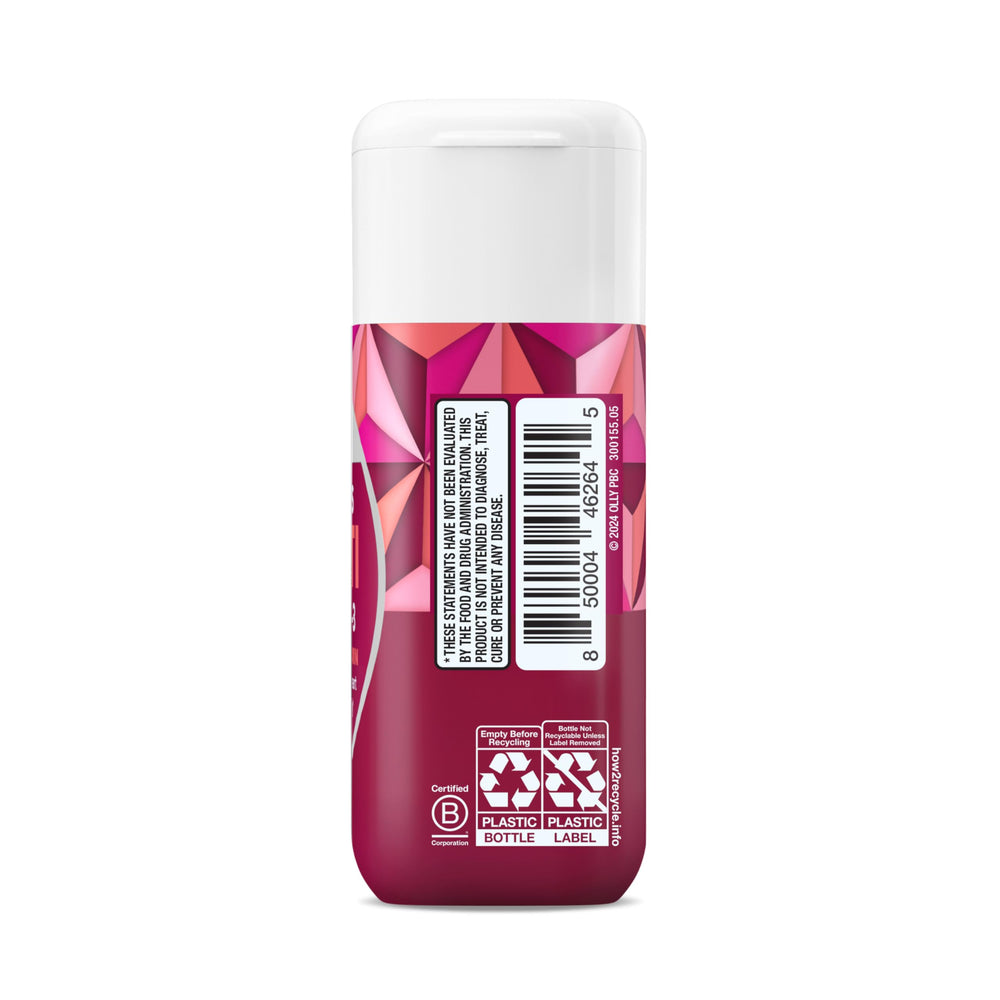 OLLY Ultra Women’s Multi Softgels bottle beside glass and vitamins.