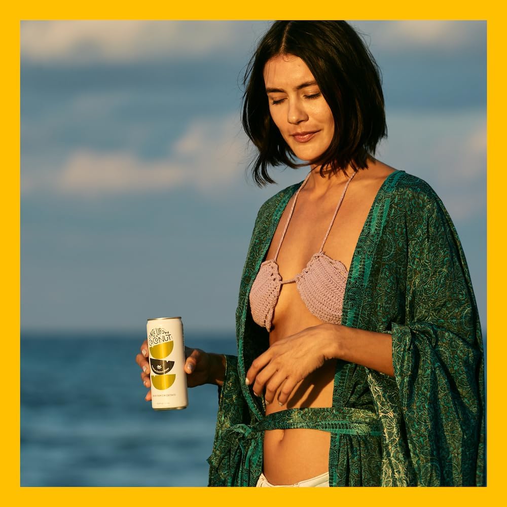 ONCE UPON A COCONUT chilled glass with straw suggests refreshing tropical flavor.