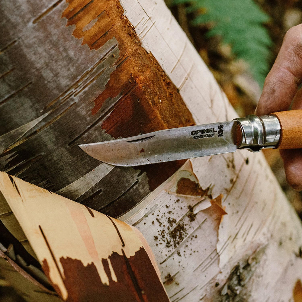 Opinel No. 08 Carbone beechwood handle grain visible in close view.
