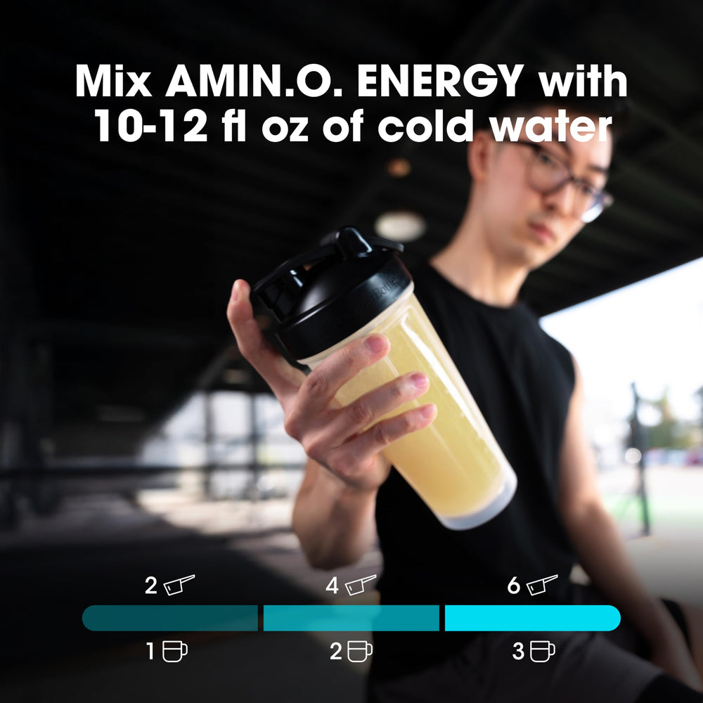 Optimum Nutrition Amin.O.Energy bottle tilted to pour into a glass for focus.