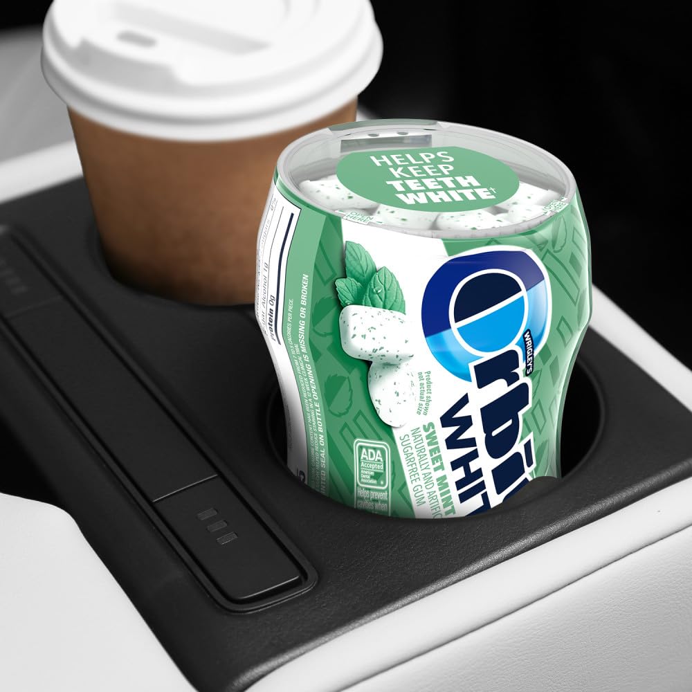 Orbit Sweet Mint gum in car cup holder for travel and on-the-go use.