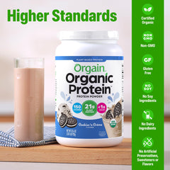 Scooping Orgain Cookies & Cream powder, perfect for on-the-go shakes