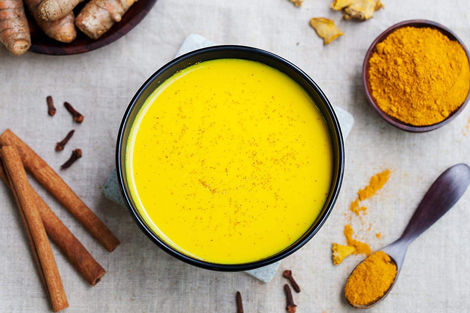 Organic Spice Resource turmeric powder stirred into golden milk for a soothing beverage idea