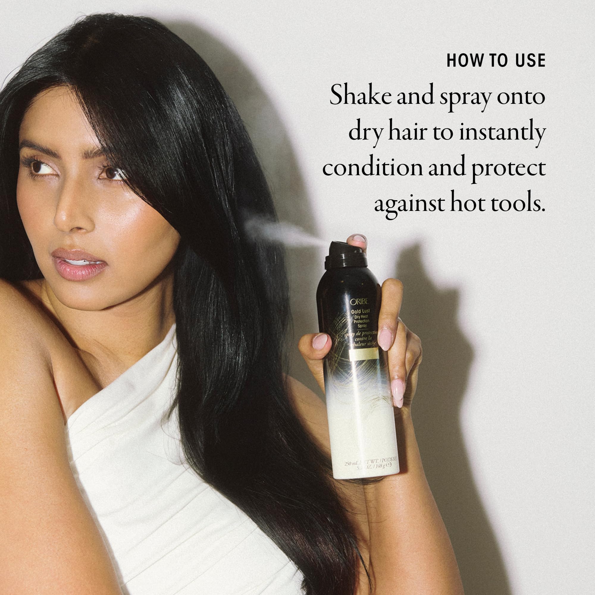 Oribe Gold Lust dry heat spray with styling tools in view