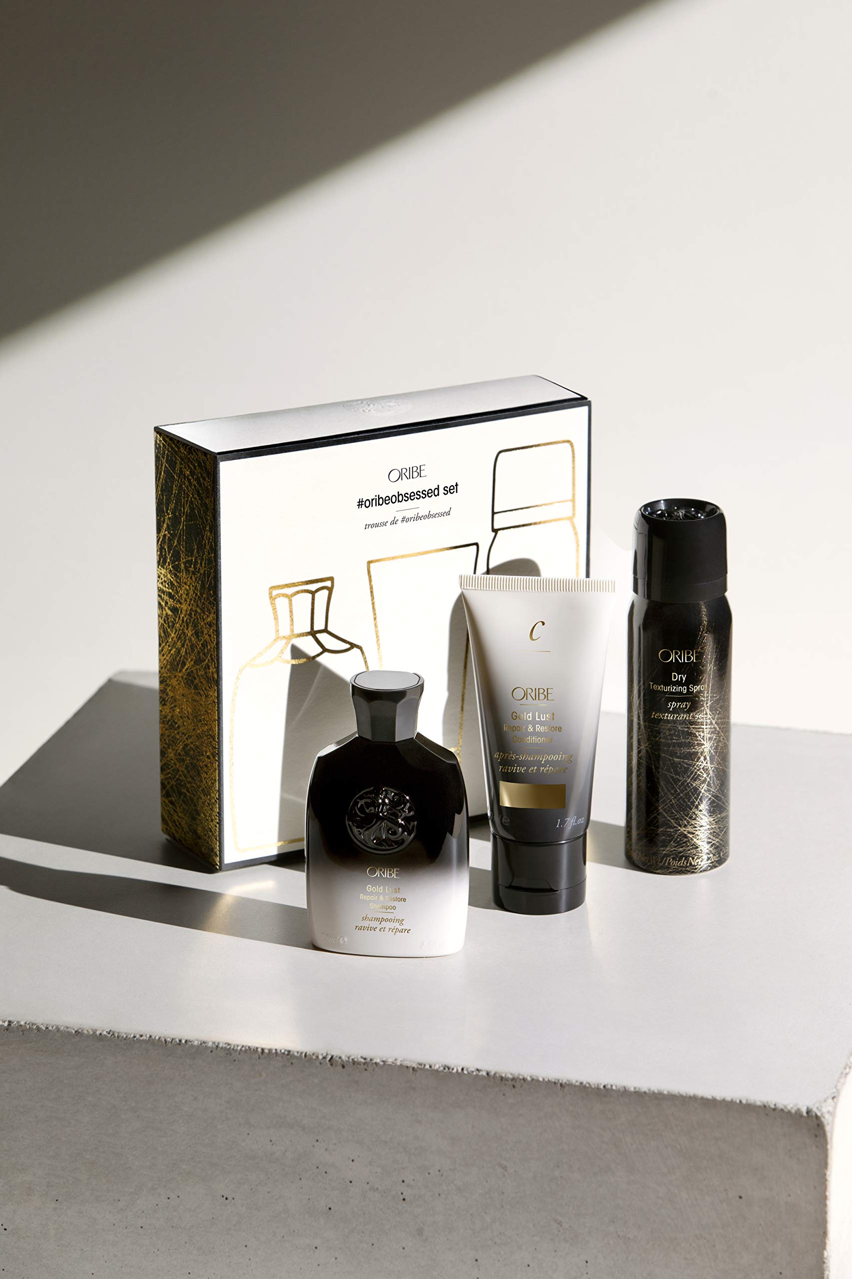 Oribe Gold Repair Restore Conditioner tube promoting moisture and softness.