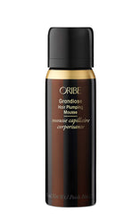 Oribe Grandiose Mousse bottle close-up highlighting volume-boosting styling for fuller hair.