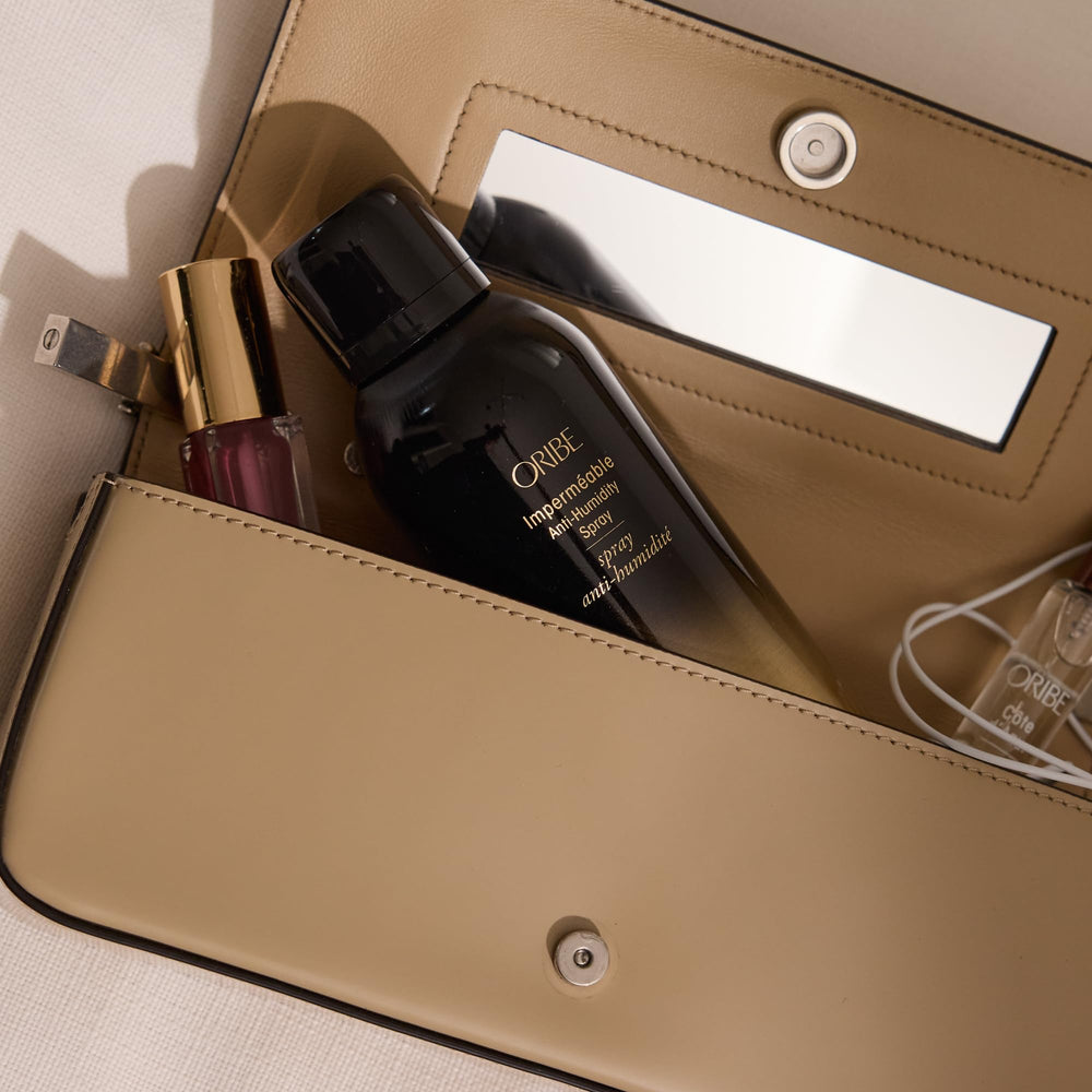Oribe Impermeable Anti-Humidity Spray finishing curls with a light hold and frizz control.
