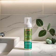ORS Olive Oil Max Moisture mousse on damp hair mid-styling.