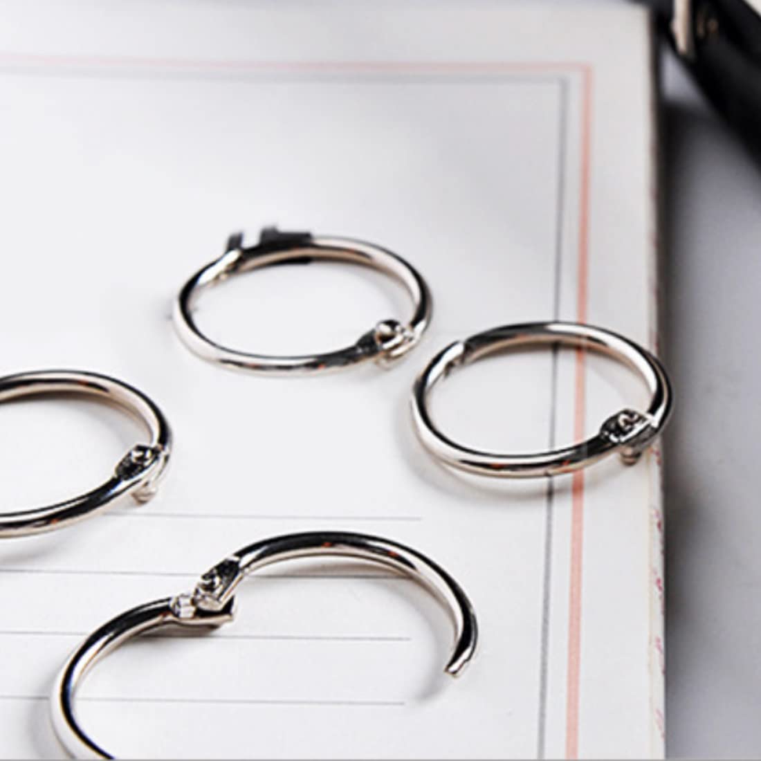 Otylzto binder rings in office setup aiding document organization.