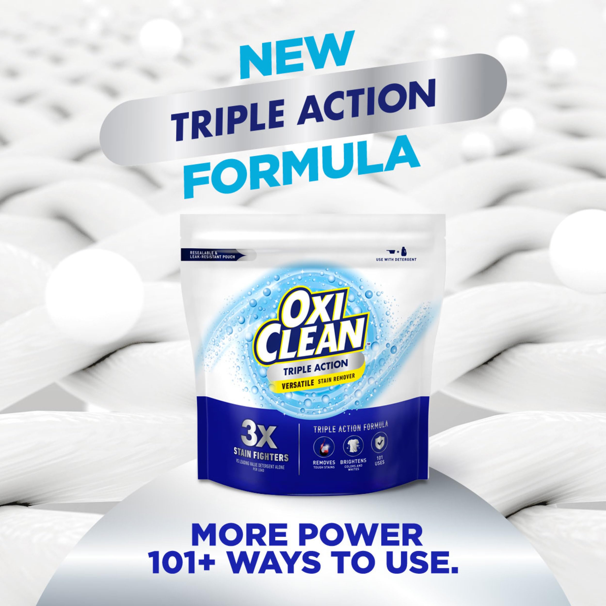 Close-up of the dosing scoop with OxiClean powder, enhancing stain removal when used with detergent.