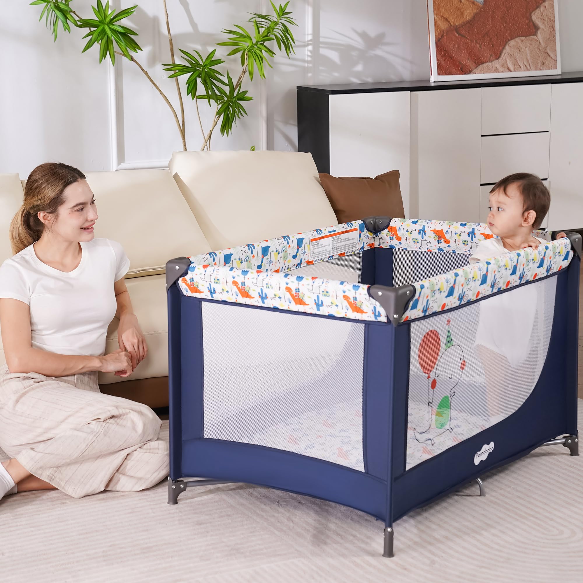 Pamo Babe lightweight travel crib in use during a family visit.
