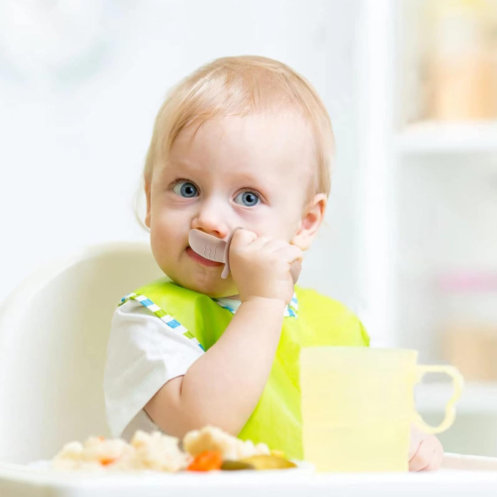 PandaEar green silicone baby spoon designed for small hands during self-feeding.