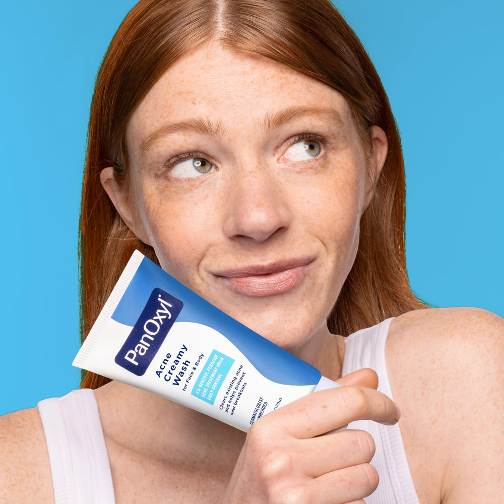 PanOxyl hands holding bottle emphasizes convenient daily skincare routine.
