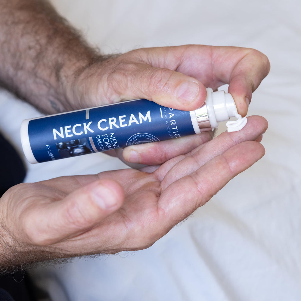 Gently massaging Particle Neck Cream into the neck during grooming routine.
