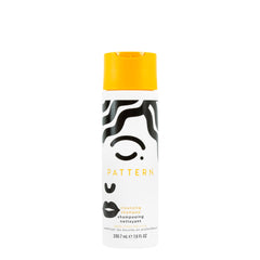 PATTERN Beauty cleansing shampoo bottle pour showing a clarifying cleanse for curls