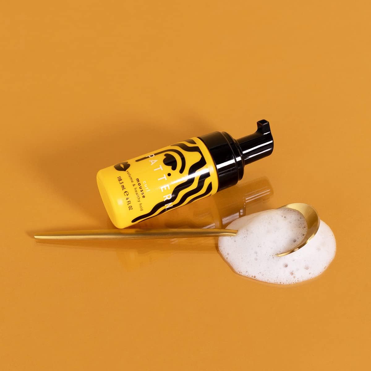 PATTERN Mini Curl Mousse applied by hands for even, lightweight curl definition.