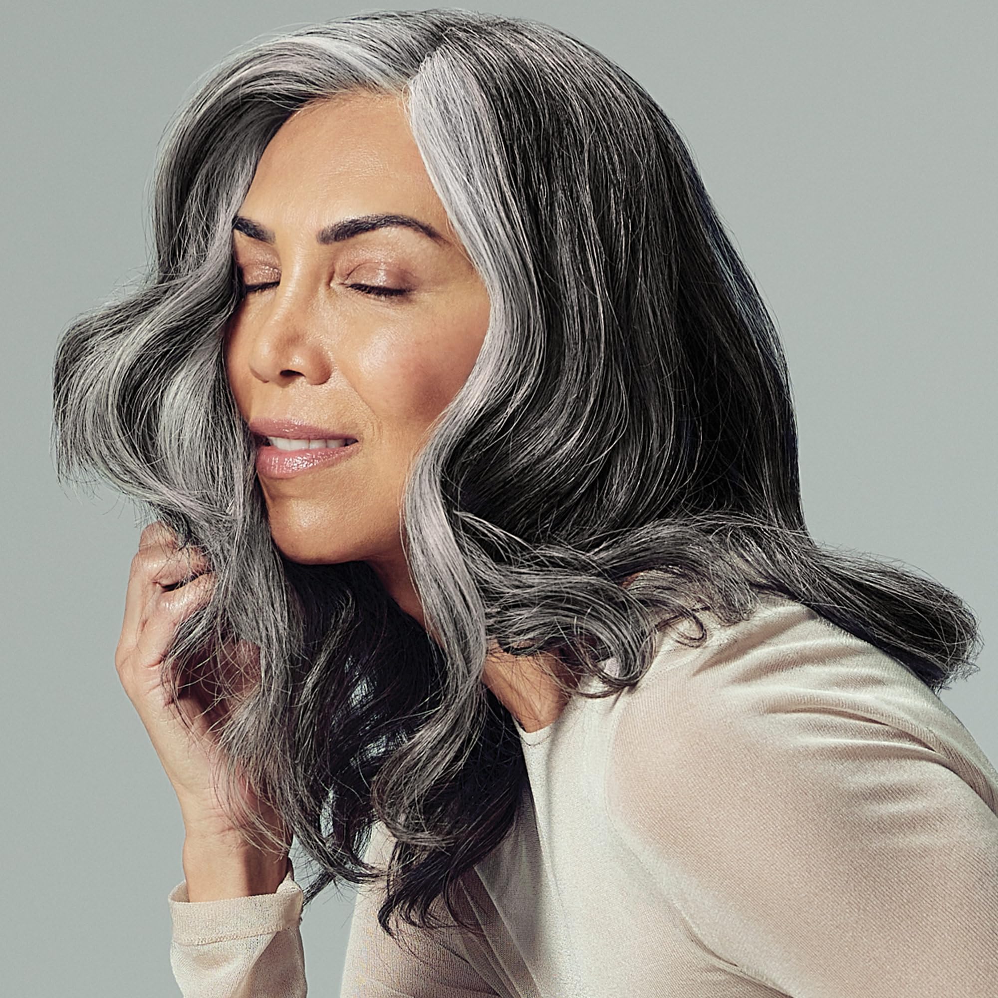 Paul Mitchell bottle applying foam during blow-drying to boost volume.