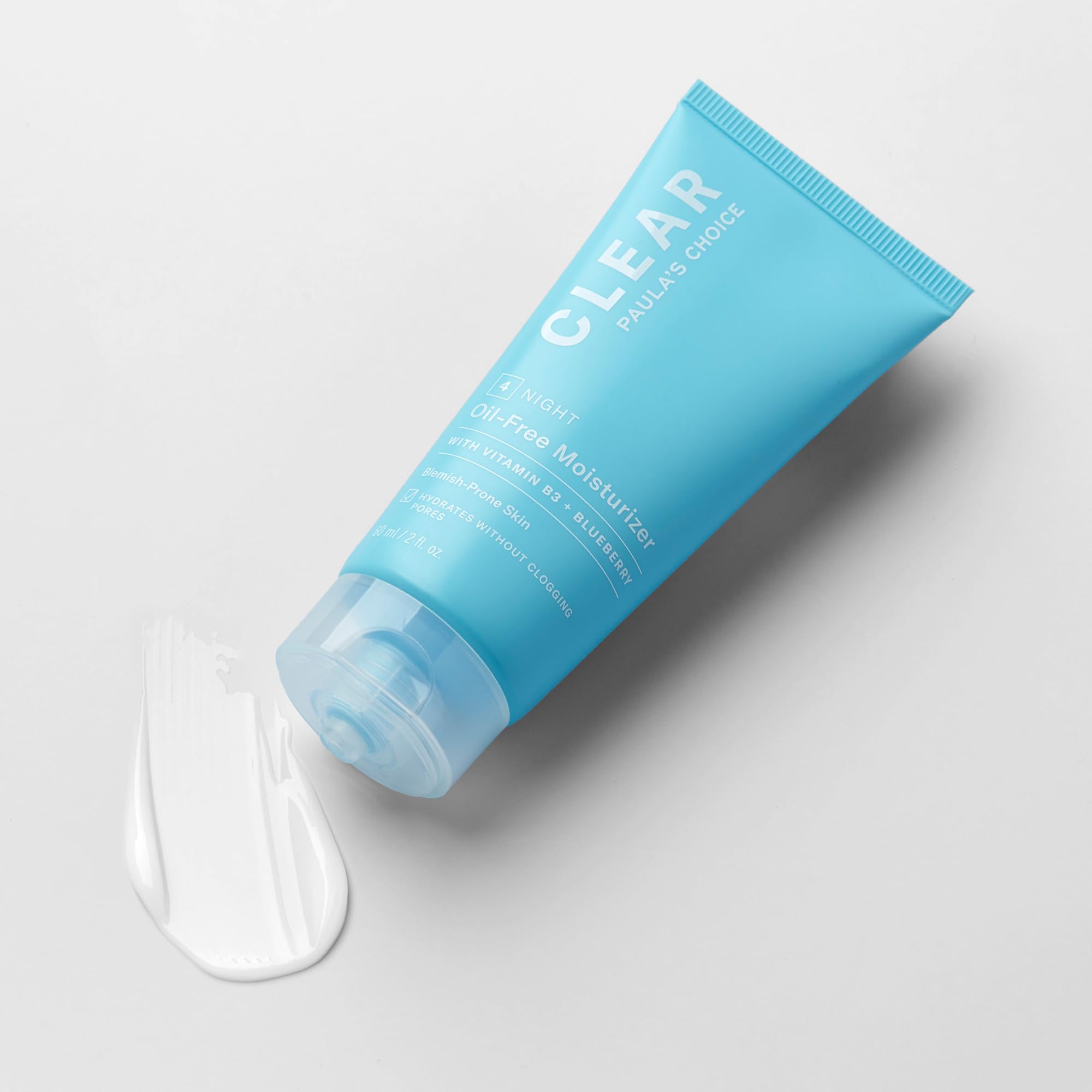 Paula's Choice CLEAR Oil-Free Moisturizer sits in a nighttime routine beside serums.