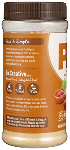 PB2 powder pouring into a shaker bottle for shakes.