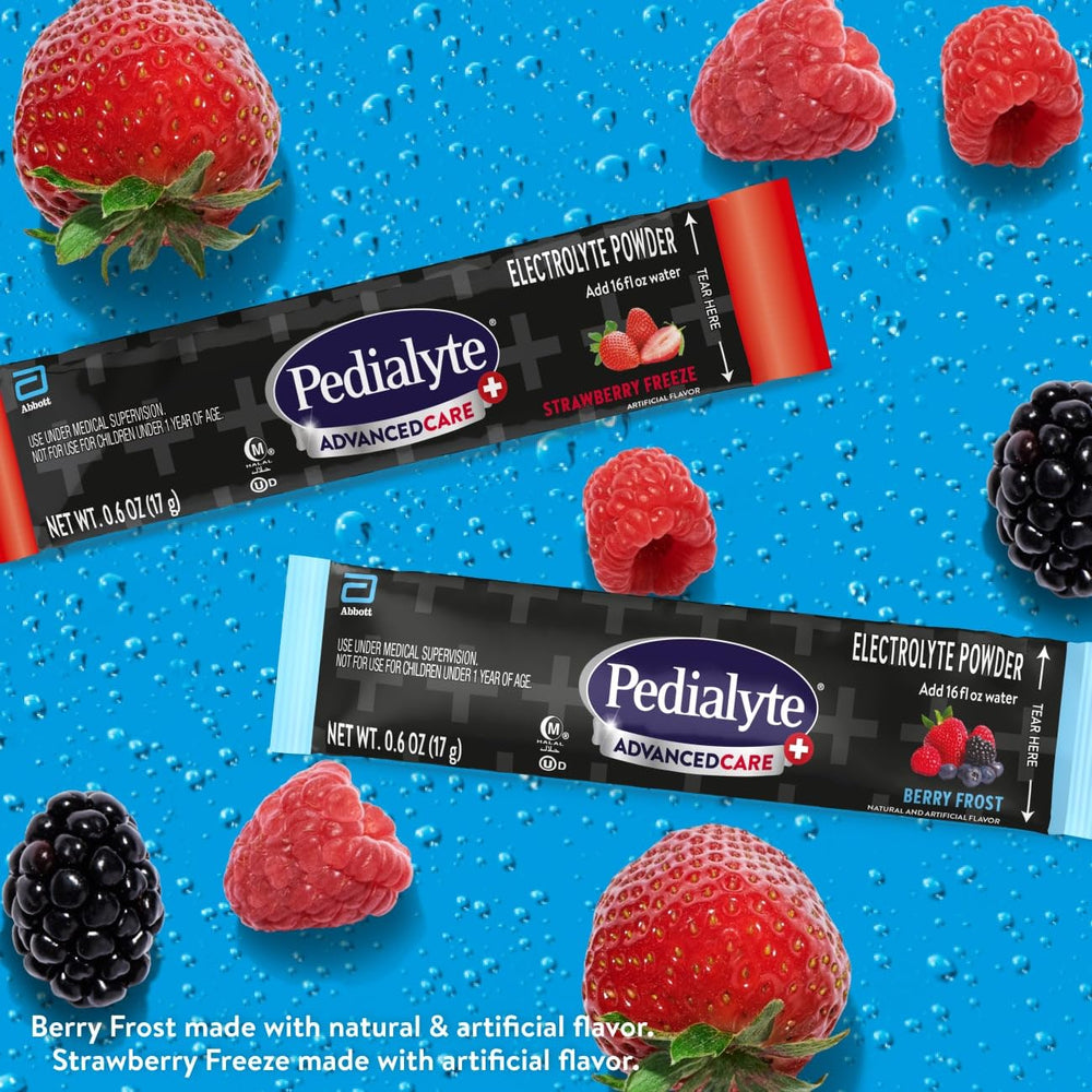 Pedialyte AdvancedCare Plus powder packets with scoop dissolving in glass.