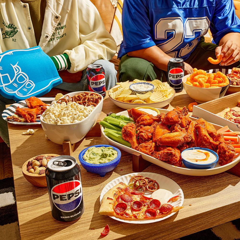 Pepsi Wild Cherry 12-pack on a table during a casual gathering.