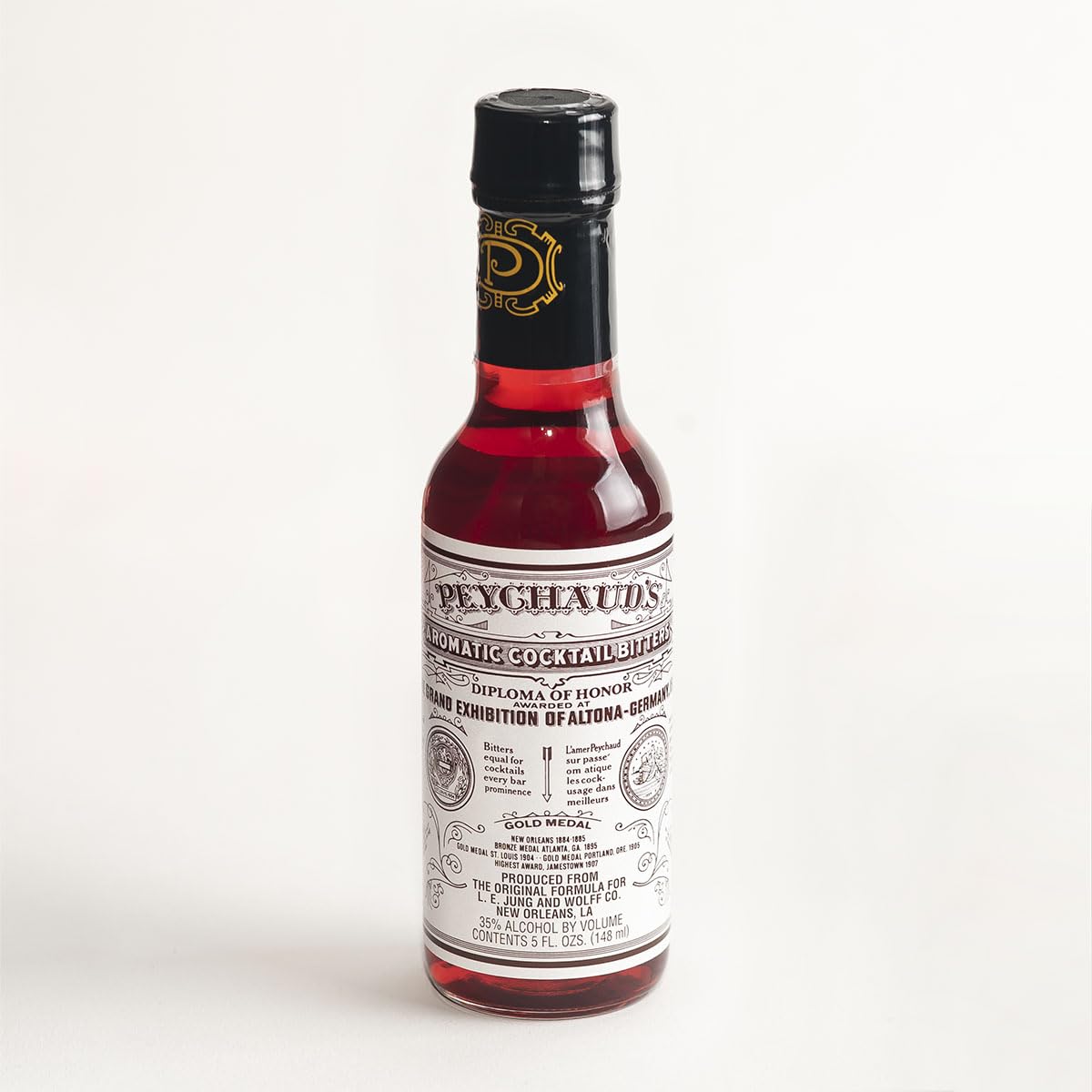 PEYCHAUD'S bottle-front label signaling heritage for authentic cocktails