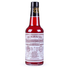 Peychaud's aromatic bitters bottle beside a classic cocktail glass, elevating cocktails.
