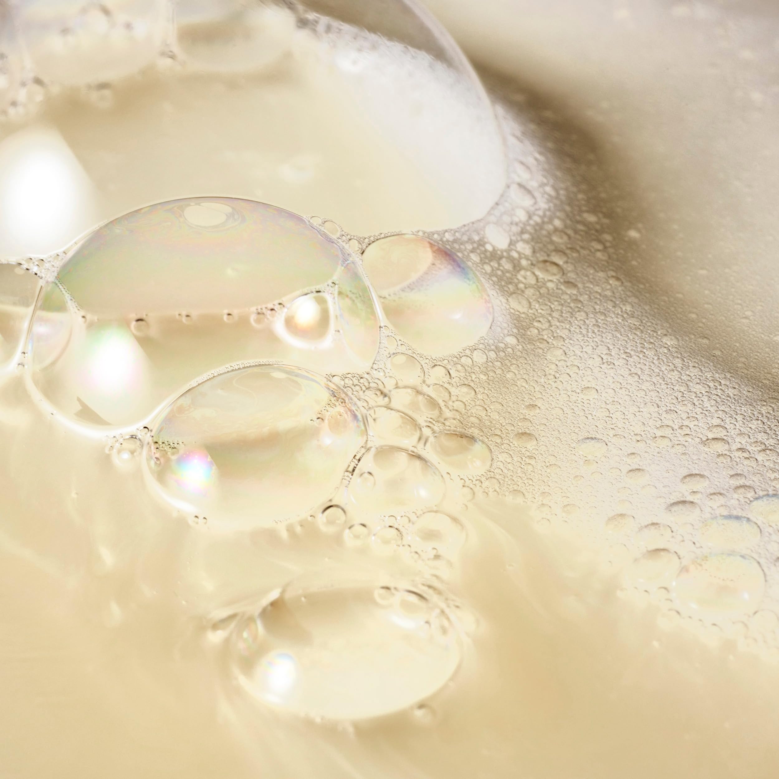 Philosophy Cinnamon Bun Shower Gel lather close-up emphasizes hair and body cleansing.
