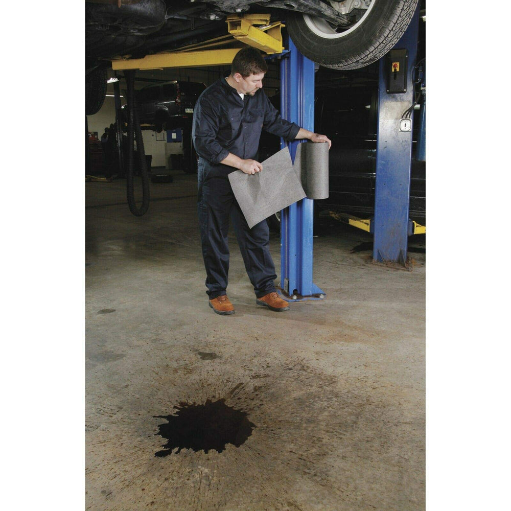 PIG Mat Roll absorbing oil and coolants to keep the workspace clean