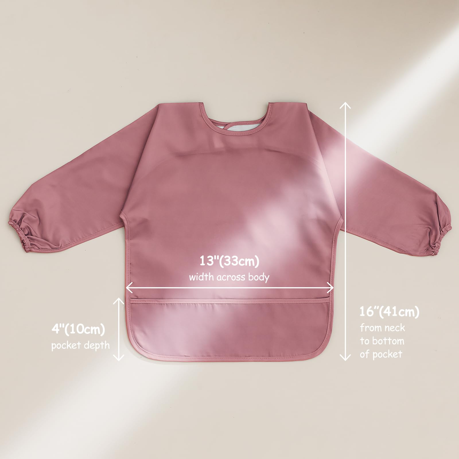 POIKSHARK pink baby bib shows a generous spill pocket for meals.