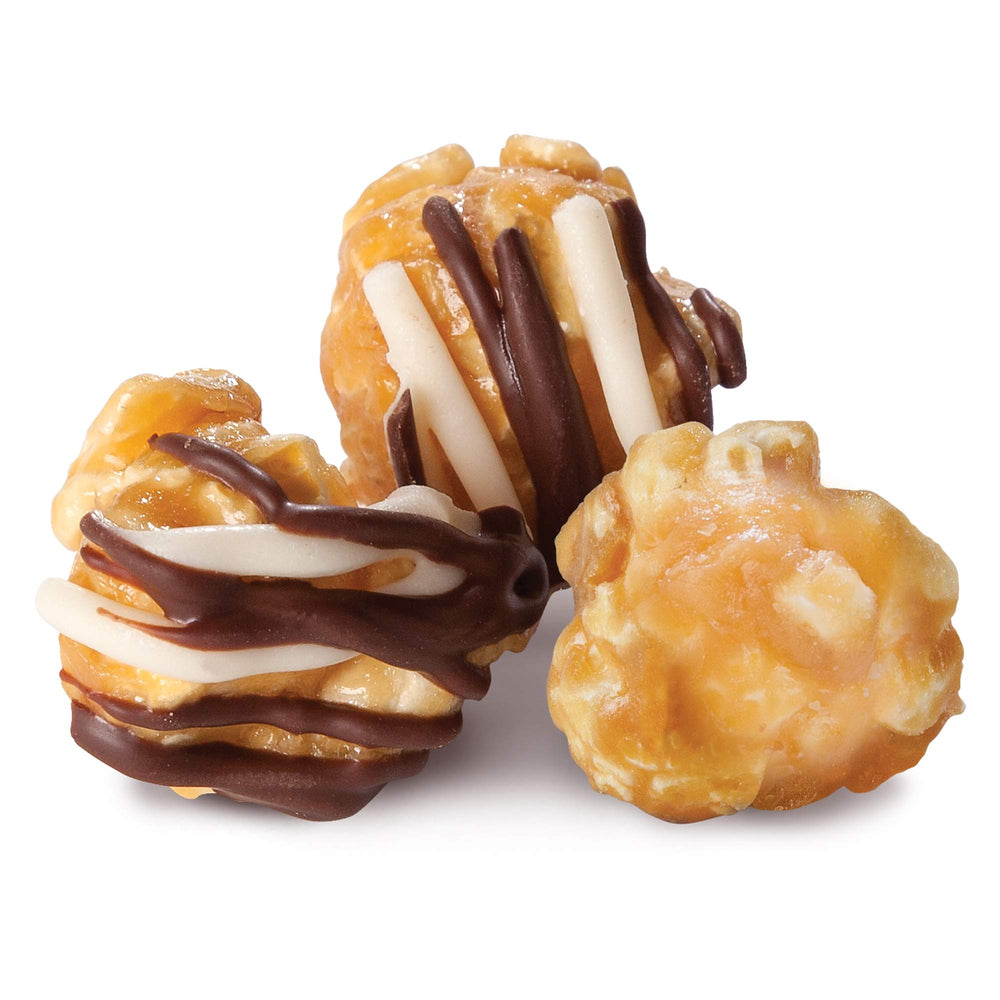 Caramel-striped zebra popcorn with chocolate drizzle close-up.