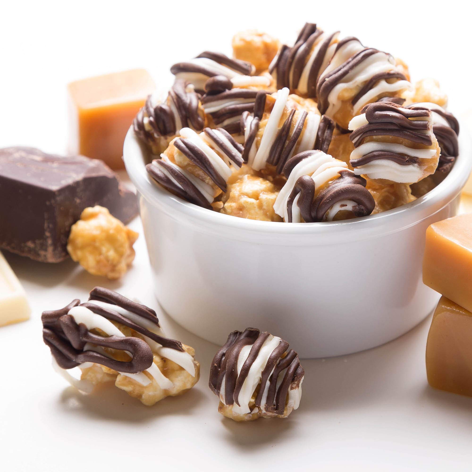 Close-up of zebra-striped popcorn with caramel and chocolate.