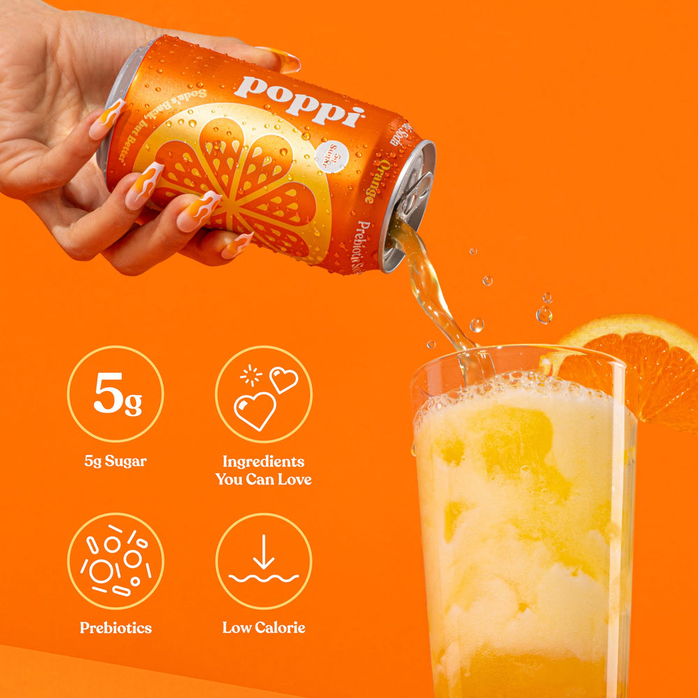 Close-up of bubbles in Poppi orange soda glass