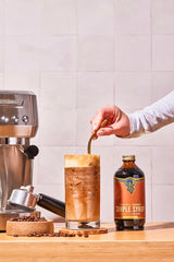 Portland Syrups Brown Sugar Simple Syrup beside a latte, smooth sweetness for coffee.