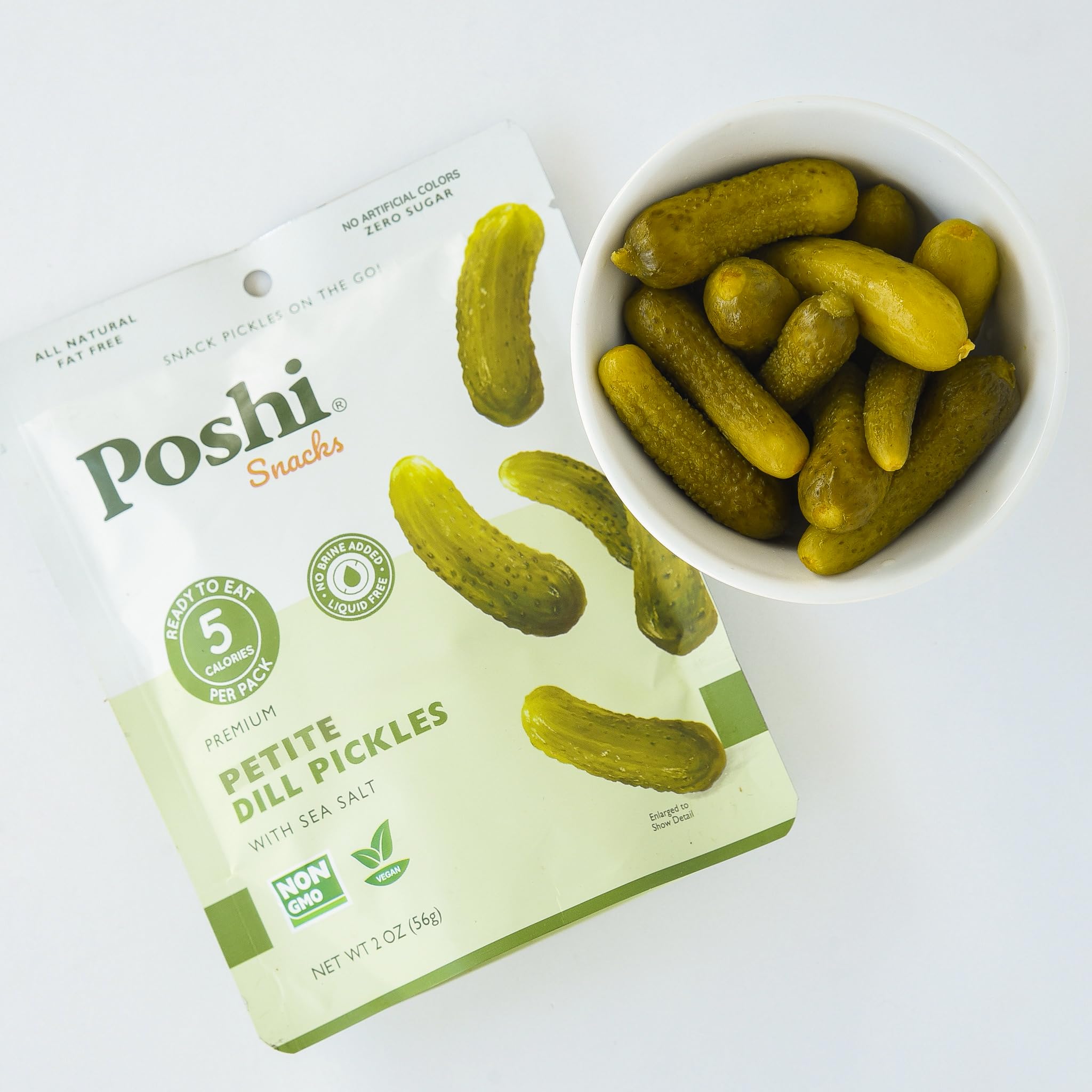 Poshi petite dill pickles 2 oz pack offering 5 calories per serving for a light snack.
