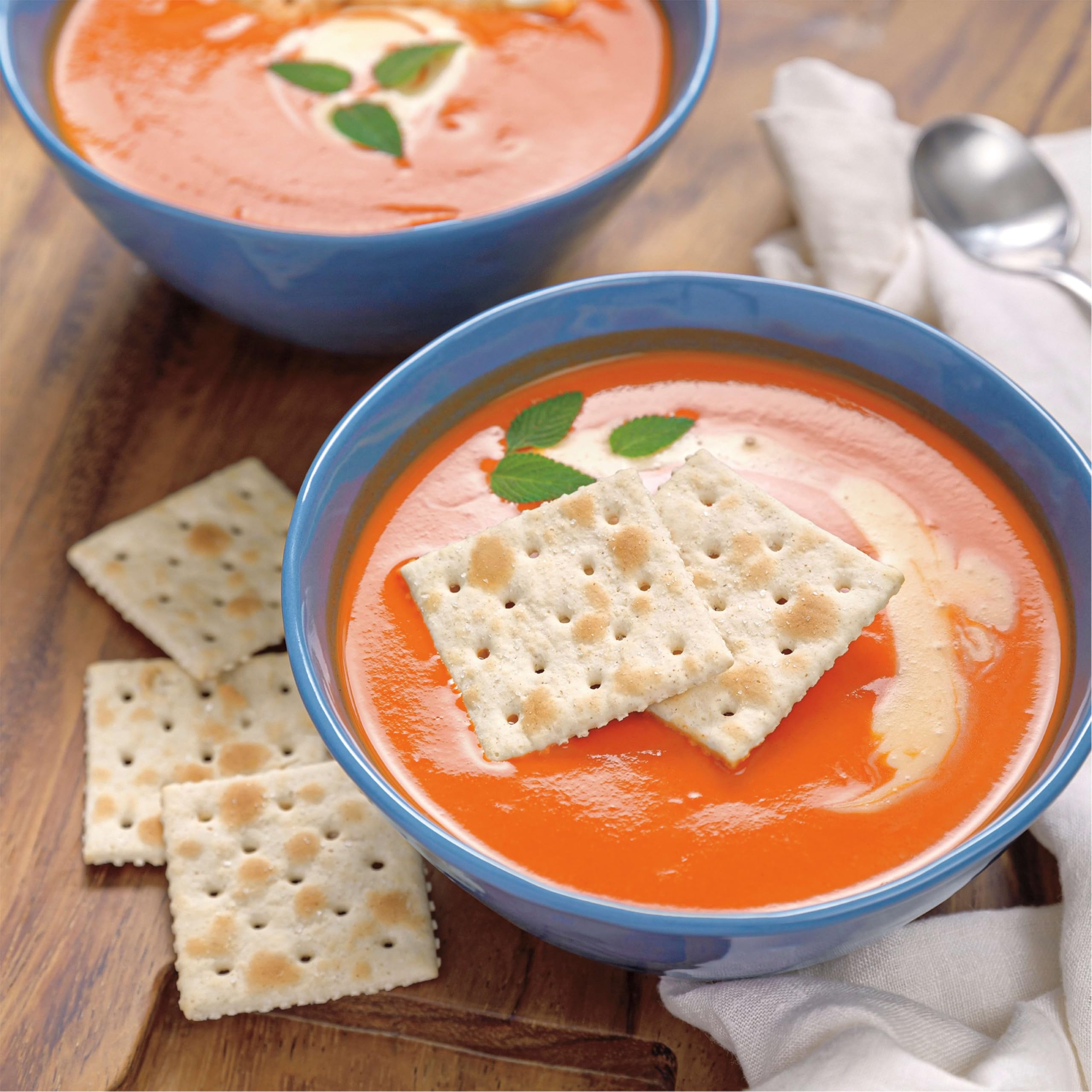 Premium Original Saltine Crackers beside cheese board offers versatile snacking.