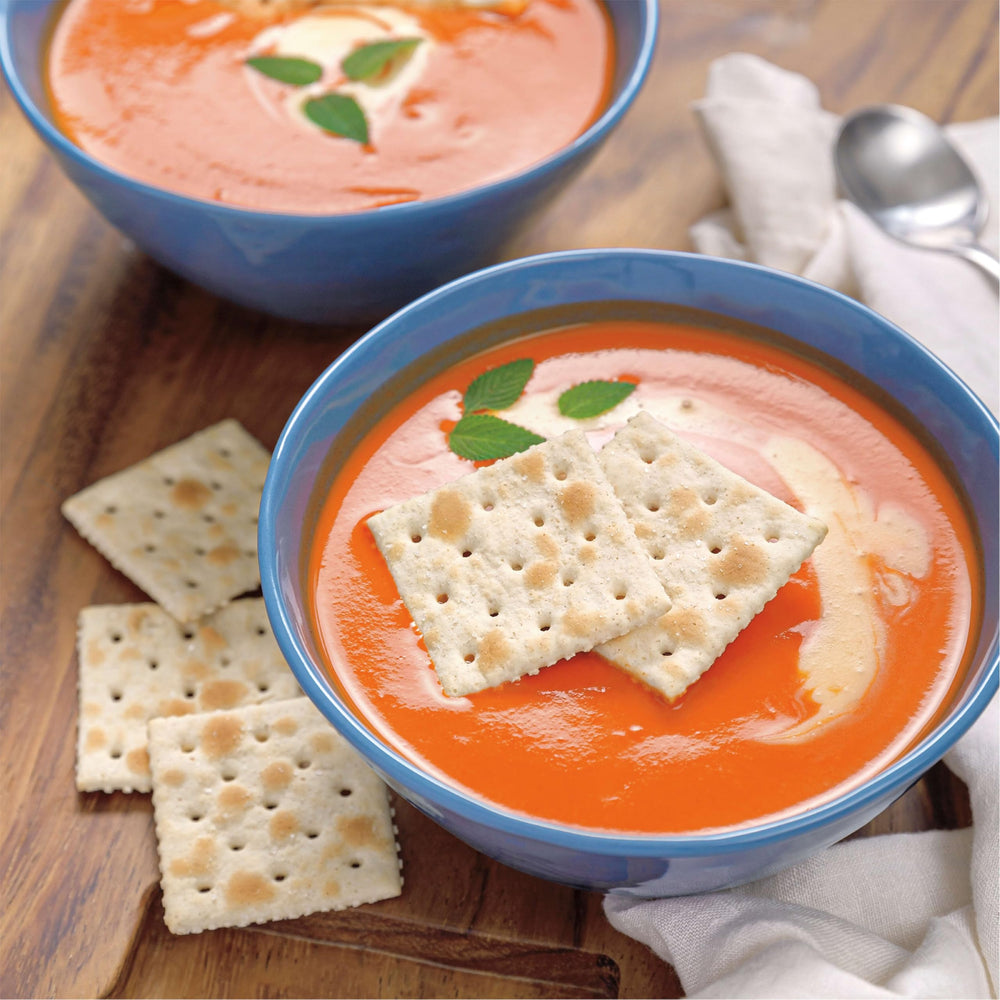 Premium Original Saltine Crackers beside cheese board offers versatile snacking.